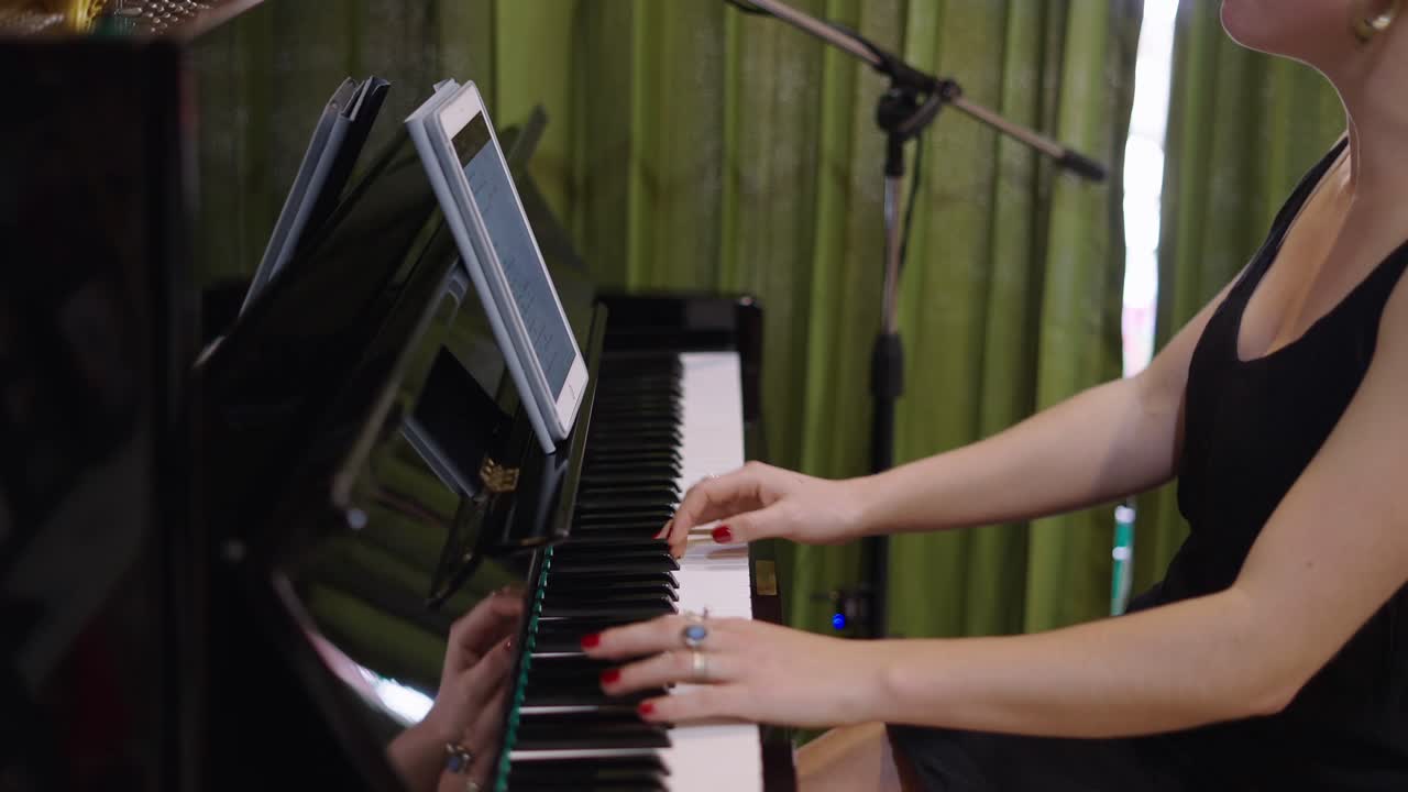 Woman Playing Piano with Tablet and Microphone