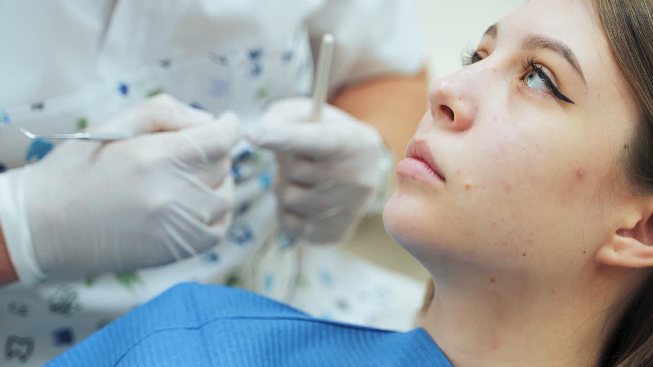 Young girl at the dentist's appointment. A doctor in medical gloves gives recommendations to the patient