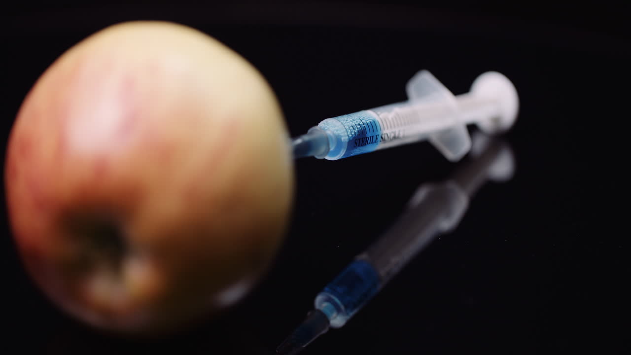Food Genetic Modification Syringle Injecting Liqquid In Apple Gmo Modification Concept 5