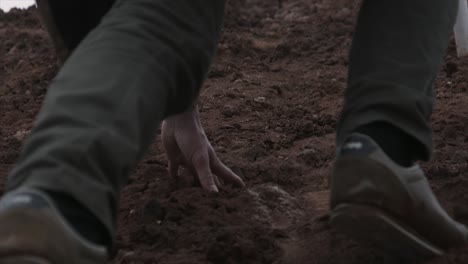 person climbing a muddy hill