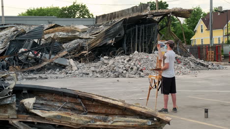 artist painting the destruction in the aftermath of the minneapolis riots