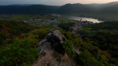 Highspeed-descending-FPV-shot-of-unique-stone-formations-on-Wachau-hills-close-to-Dürnstein,-Austria