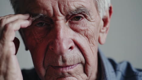 close-up of an elderly man with a stressed or worried expression