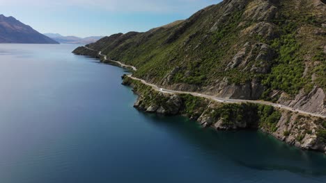 beautiful winding road beside lake wakatipu, new zealand