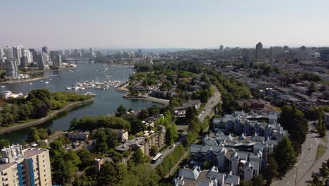 2-4 aerial panaramic fly over granville island false creek residential commercial luxury modern lowrise community by the yacht clubs and the lush green parks in downtown vancouver canada east view