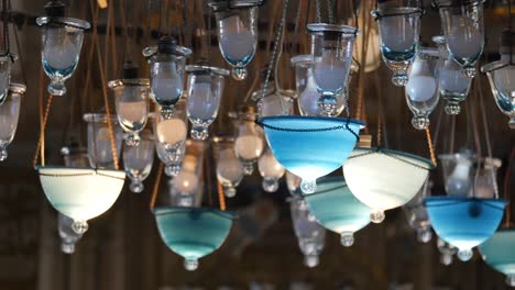 collection of hanging glass lamps with blue and white illumination