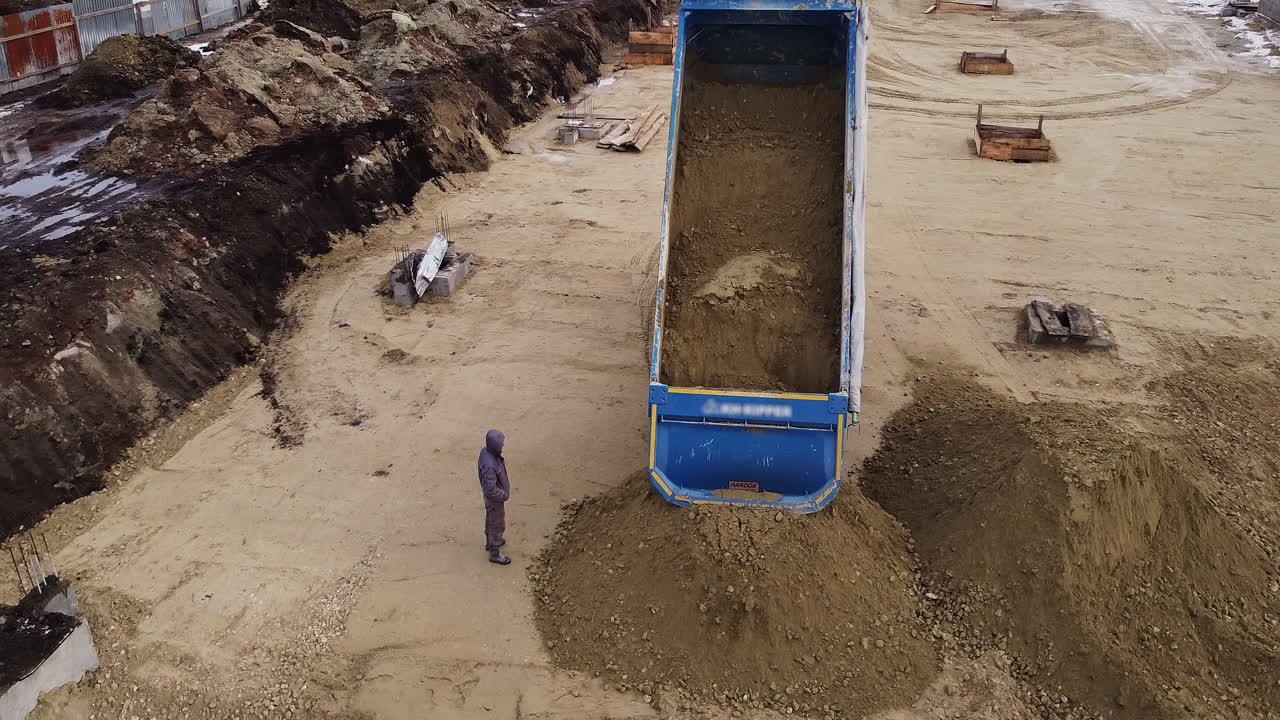 Dump Truck Loading Gravel at Construction Site