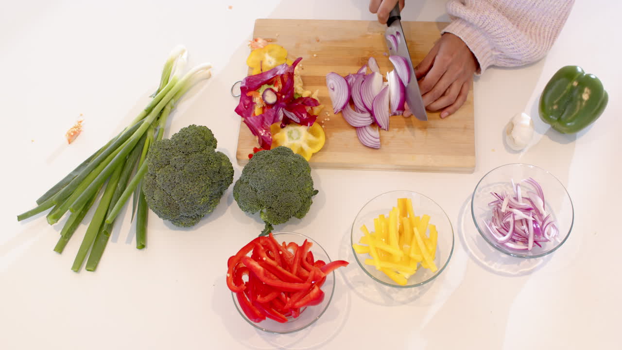 Preparing colorful ingredients, chopping fresh vegetables on cutting board in kitchen