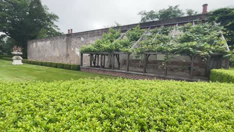 views around a garden with hedgerows and small building