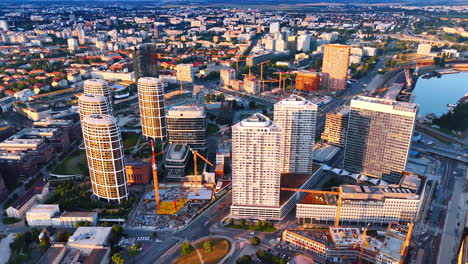 contemporary high-rises in the urban landscape of bratislava, slovakia. lots of construction sites are in the city. aerial perspective