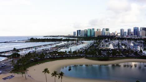 Drone-shot-pulling-away-from-an-Oahu-boat-marina-near-the-Rainbow-Tower