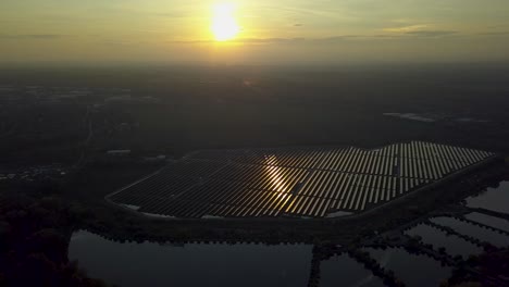 aerial view of solar panels with scenic sunset in hungary - drone flying shot