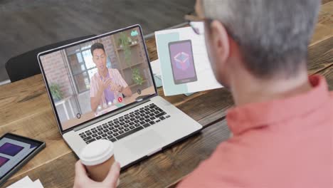 Caucasian-businessman-on-laptop-video-call-with-caucasian-male-colleague-on-screen