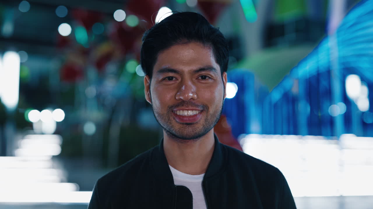 Smiling Asian Man in a City at Night