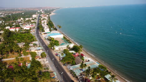 coastal main road of mui ne with luxury hotels and buildings, aerial view