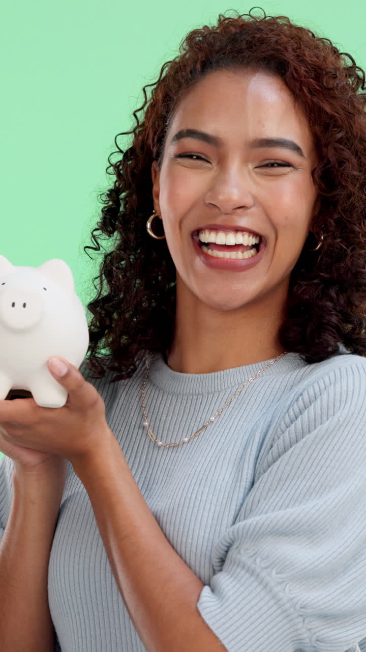 Happy Young Woman Holding Piggy Bank and Laughing