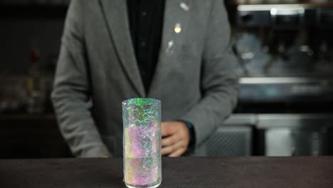 bartender preparing a colorful cocktail