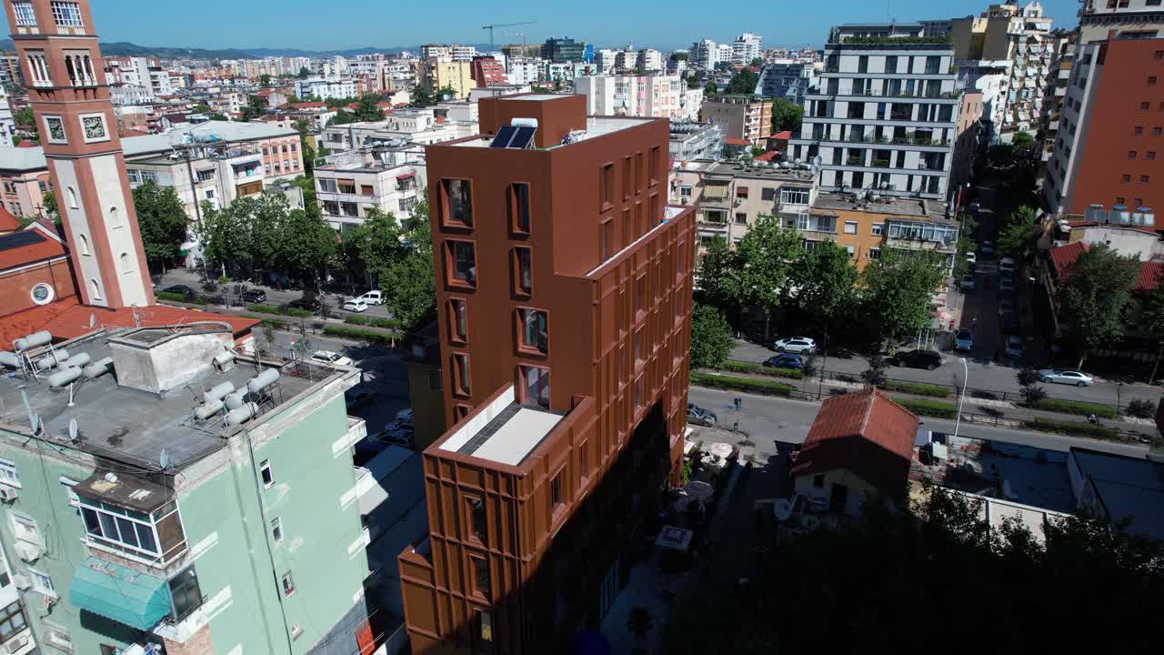 Tirana urban vibrancy with contrasting architecture, vehicle traffic, real estate development, growing city streets