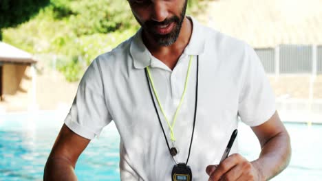 male trainer writing on clipboard