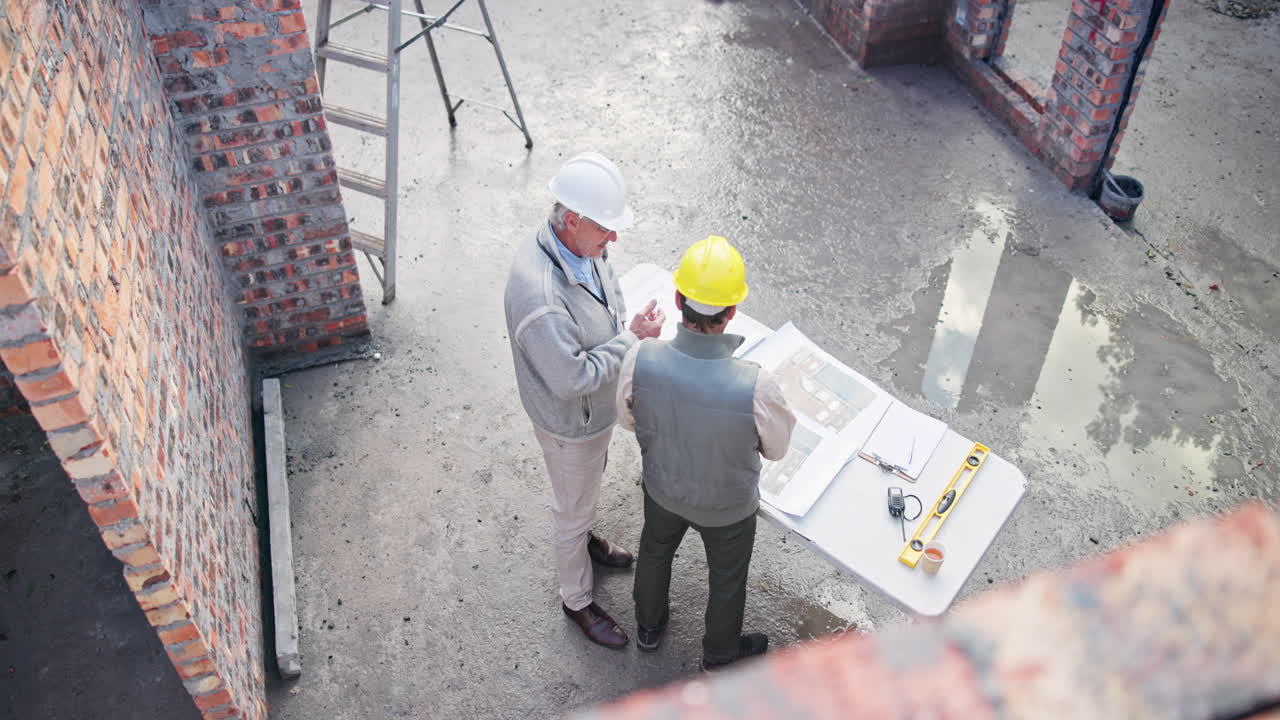 Construction workers reviewing plans on site