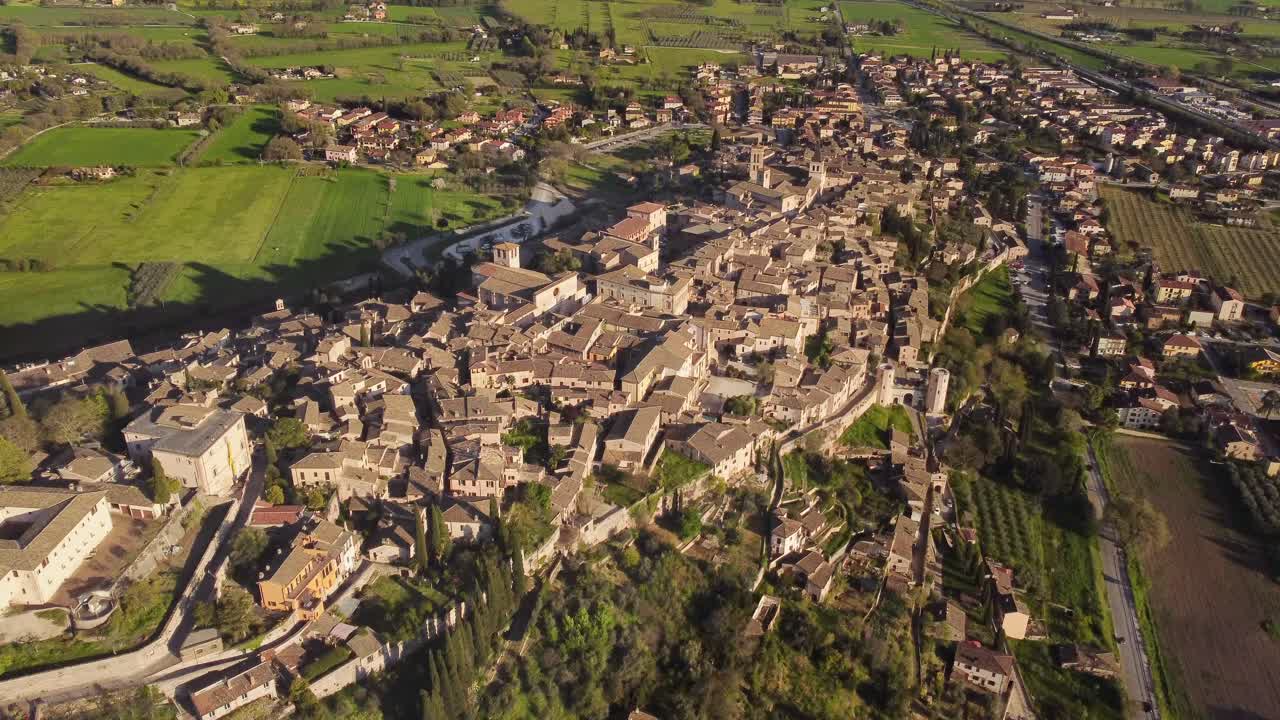 Aerial view of Spello's village, Umbria, Italy, establishing, sunny, 4k
