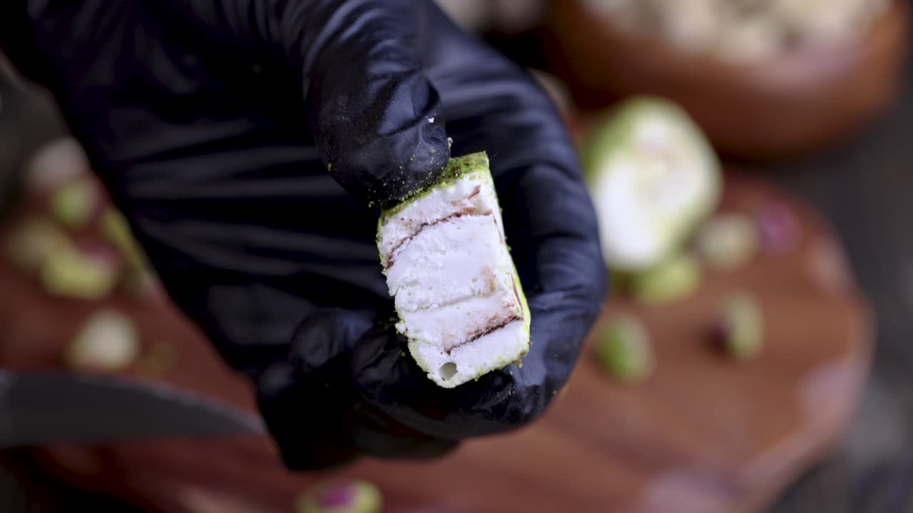 poner delicias turcas frescas con pistachos triturados y chocolate en una tabla