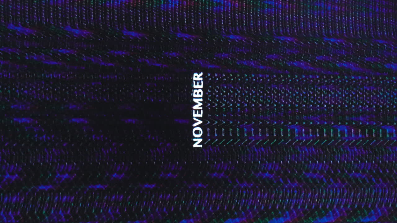 la palabra noviembre se interrumpe y se repite verticalmente a través de un fondo analógico oscuro
