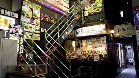 person walking down an alley in japan at night