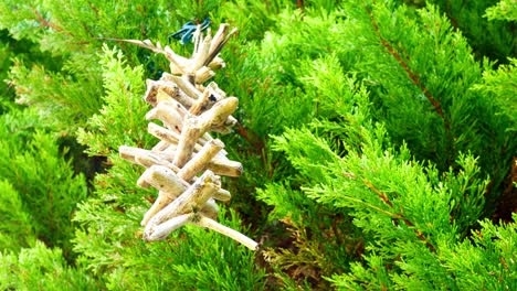 Simple-driftwood-wooden-folklore-Valhalla-ladder-spinning-in-breeze-hung-in-garden