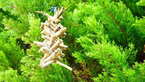 simple driftwood wooden folklore valhalla ladder spinning in breeze hung in garden