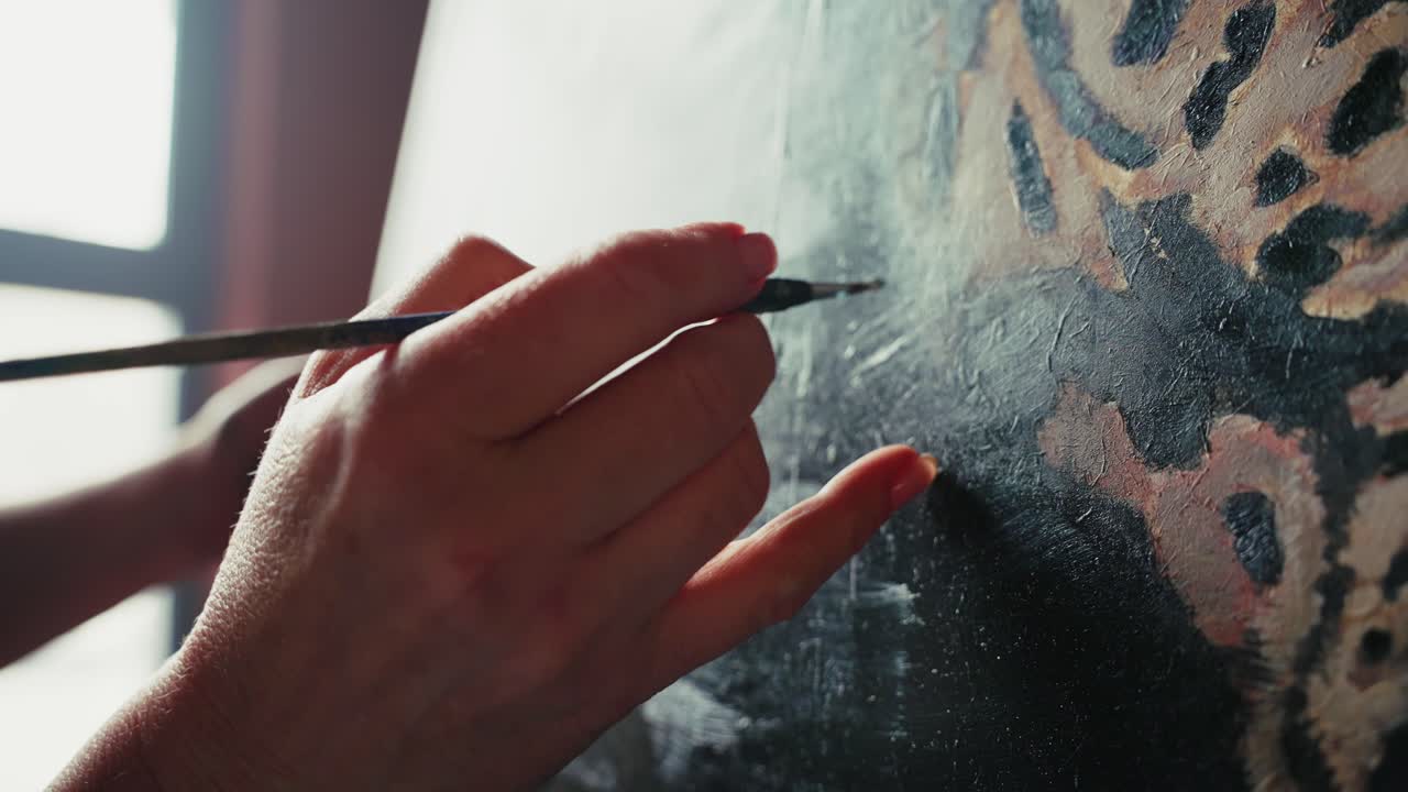 Artist painting a detail of an oil painting