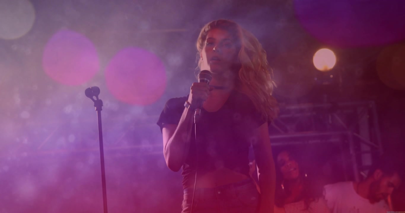 Lead singer on stage whipping hair sparking mic waveform settling to steady pose to emphasize music
