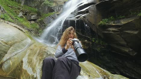 traveler photographing scenic view in forest