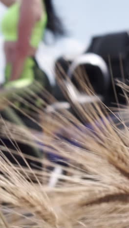 woman in green workout clothes amidst a wheat field