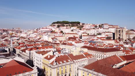 drone flying sideway to the city harbour of portugal lisbon europe with cruise ship on a bright and sunny winter day