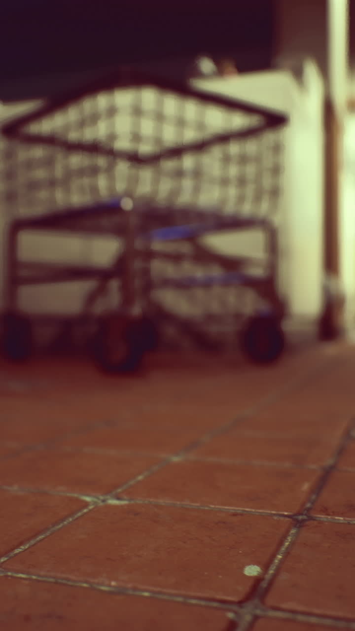 Shopping carts on a tiled floor in a dimly lit store aisle at night