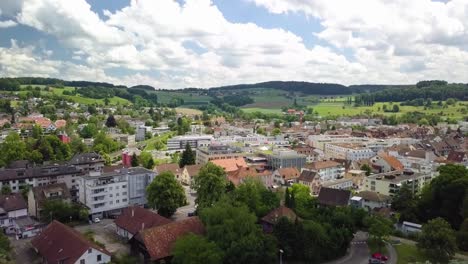 flying backwards over the beautiful city of bã¼lach in the summer