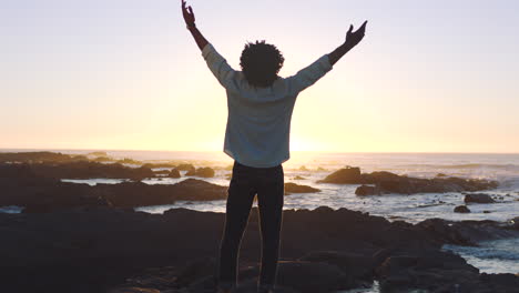 silhouette of a man feeling free at the beach