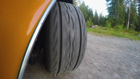 4k close-up of a car reversing from a dirt road and after driving on a asphalt road