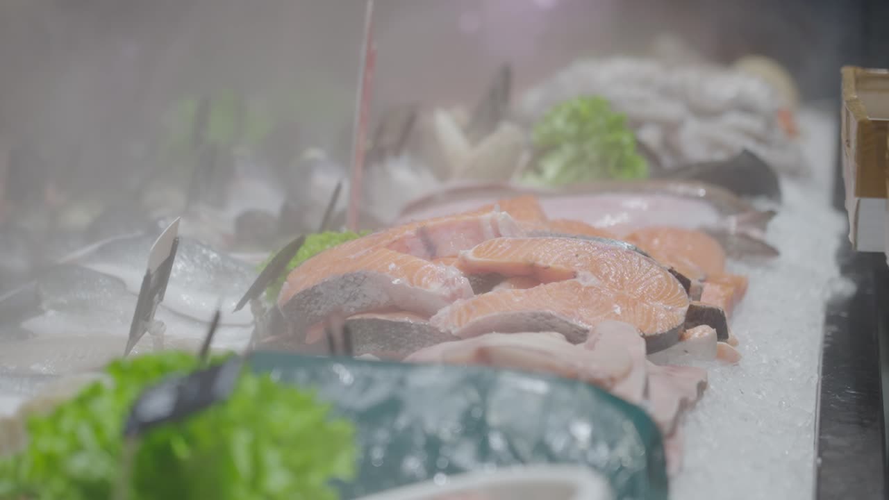 Close-up view about some fresh fish salmon displayed at fishmonger on fish tray.