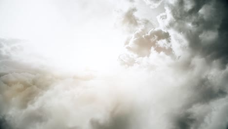 sunshine behind the thick cumulonimbus clouds in the sky