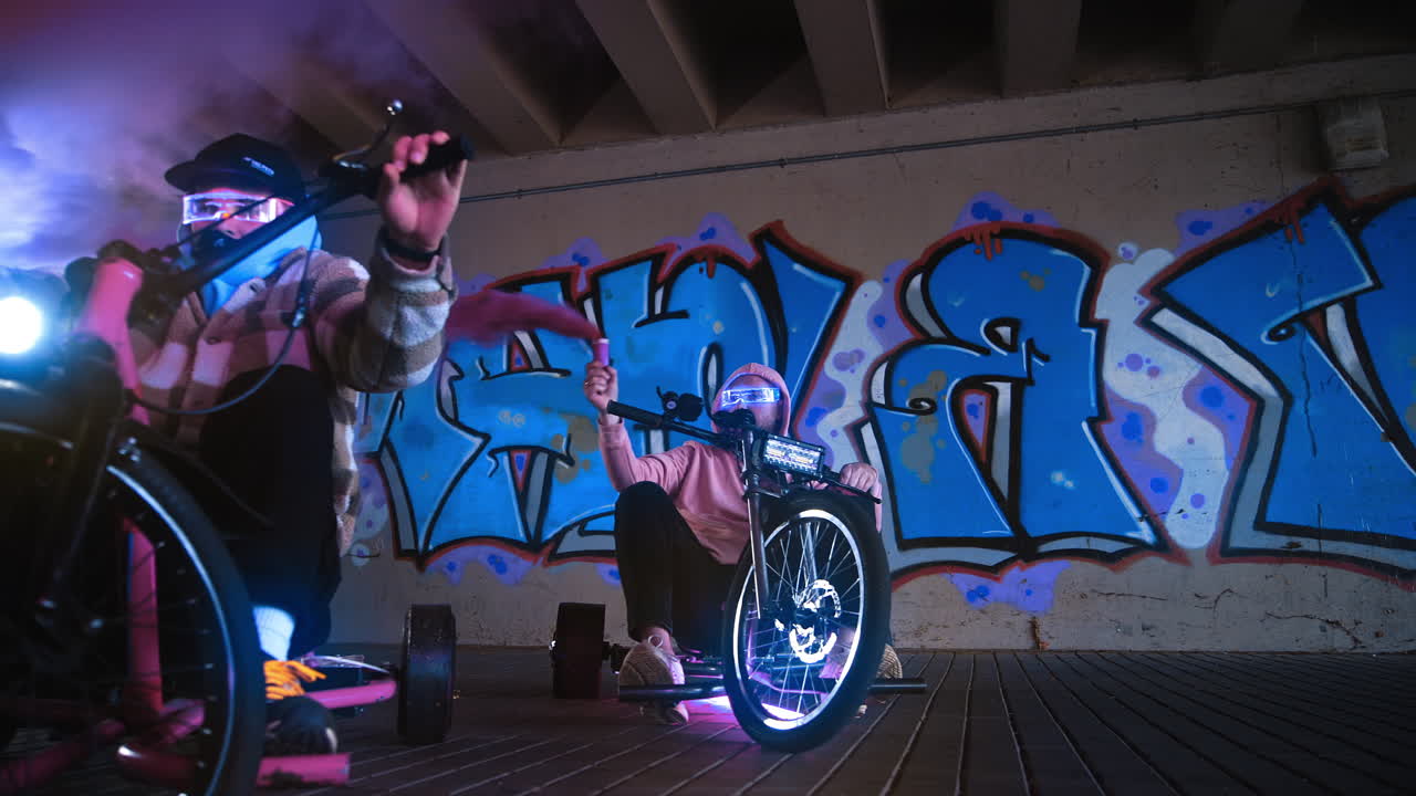 Embarking on a vibrant urban biking adventure beneath colorful graffiti artwork in the city