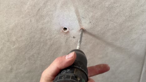 detailed plan of a drill drilling a smooth wall of a house