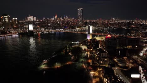 night view of brooklyn bridge at manhattan in new york united states. city at night scene. illuminated bridge landscape. brooklyn bridge at new york united states. iconic bridge.