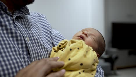 A-serene-moment-as-a-1-week-old-infant-peacefully-rests-in-the-loving-embrace-of-their-parent's-arms