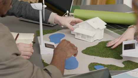 close up of a multiethnic business team discussing about renewable energy project in the office