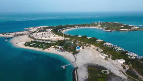 drone footage showcasing nurai island's beautiful sandy shores, clear blue waters, and opulent hideaways