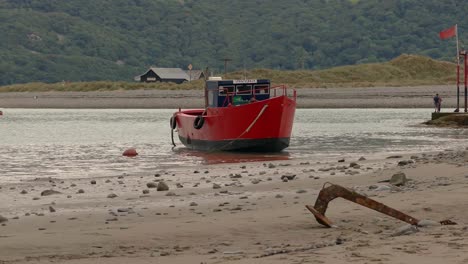 Relic-boats-on-the-beach-at-Barmouth,-Gwynedd,-Wales-UK