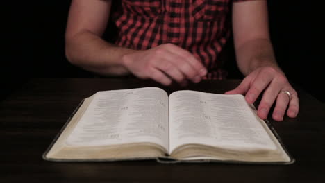 close up of millennial caucasian male reading a bible