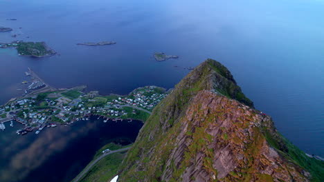 Aerial-forwarding-drone-shot-of-mountain-ridge-lit-up-by-the-midnight-sun-on-Reinebringen-in-Lofoten